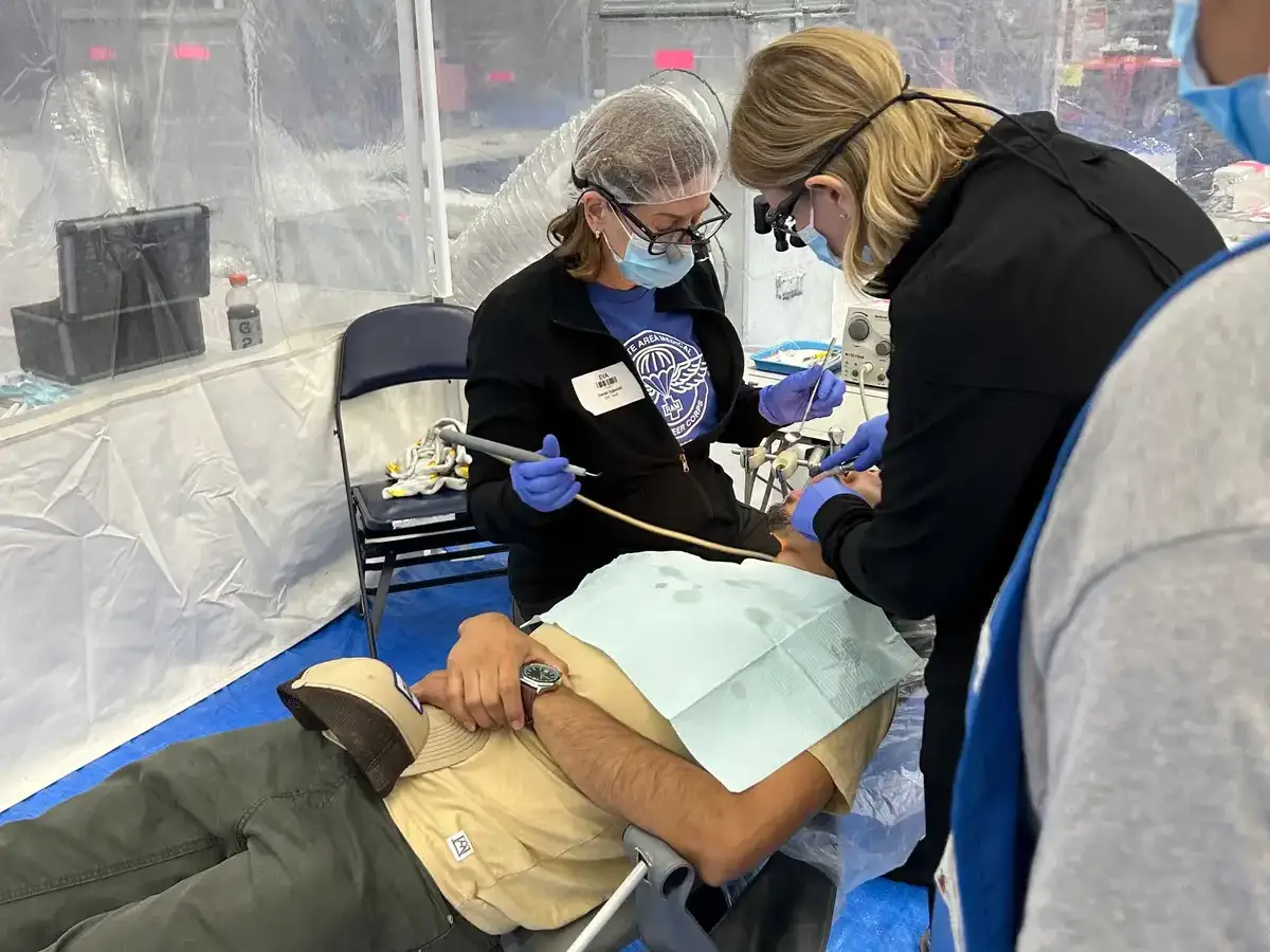 Man smiling holding a power tool